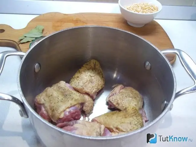 The duck is cut into pieces and put in a saucepan