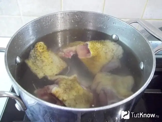 The duck is covered with water and steamed on the stove to cook