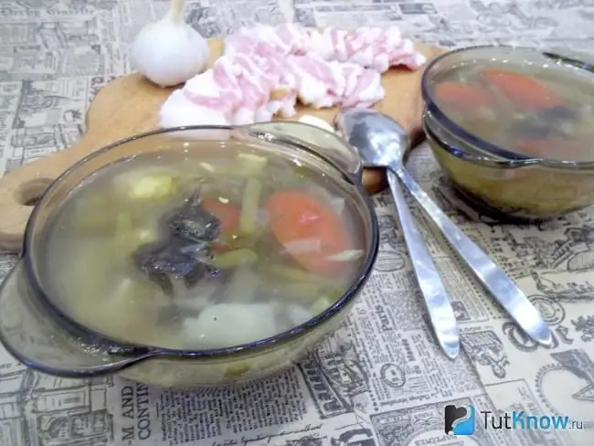 Ready-made vegetable broth soup with asparagus beans and tomatoes