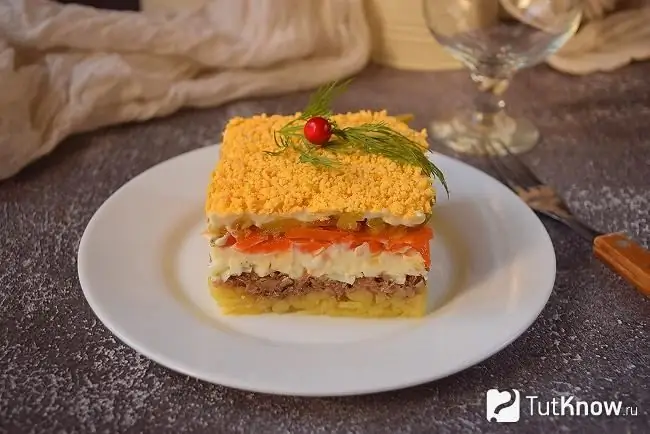 Ready-made puff salad with sprats on the festive table