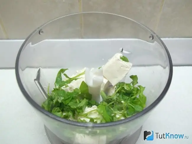 Cheese and cilantro are placed in the grinder