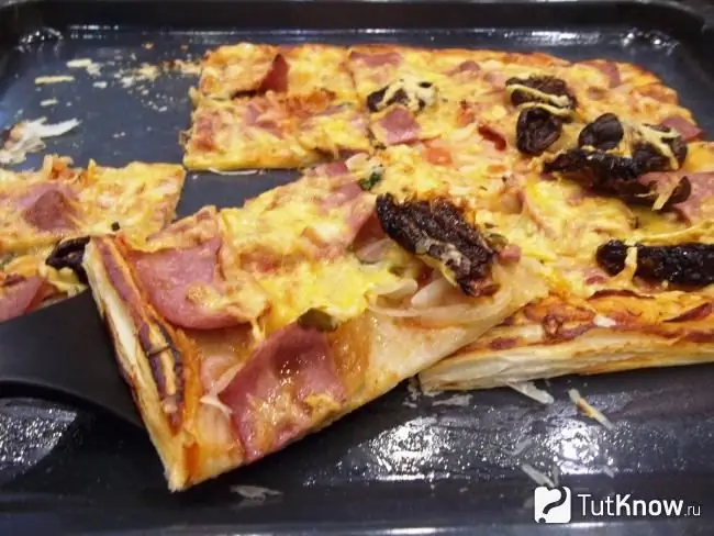 Ready-made puff pastry pizza with sausage, cheese and sun-dried tomatoes