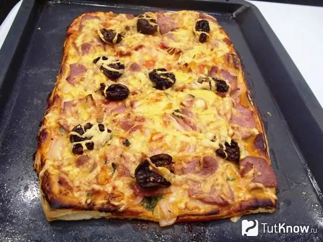 Ready-made puff pastry pizza with sausage, cheese and sun-dried tomatoes