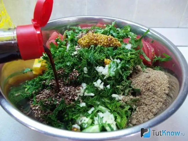 Food is stacked in a bowl, seeds and dressing added