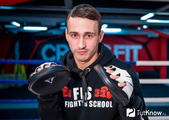 Young guy in boxing paws