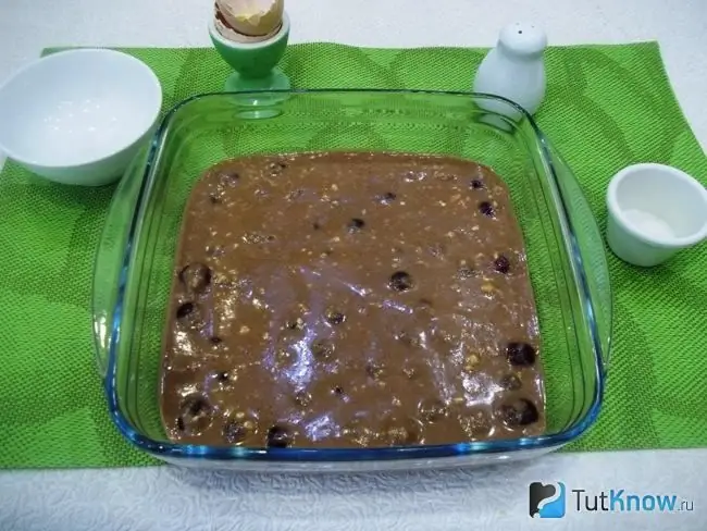 The dough is poured into the form with cherries and sent to bake