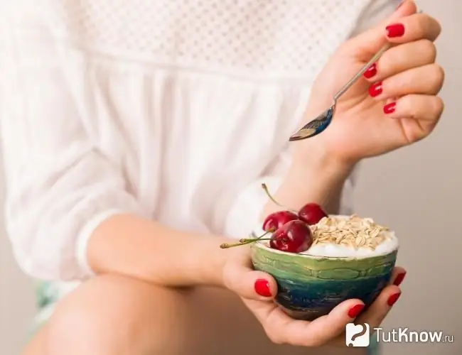 Woman eating vanilla dessert