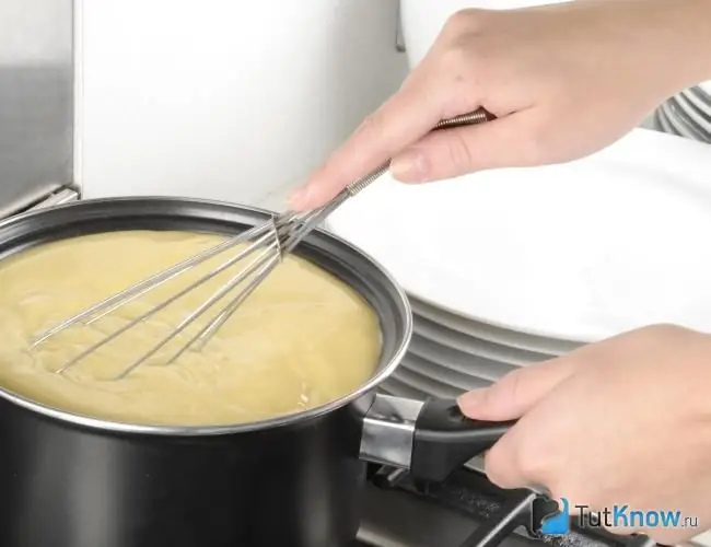 Woman preparing vanilla sauce