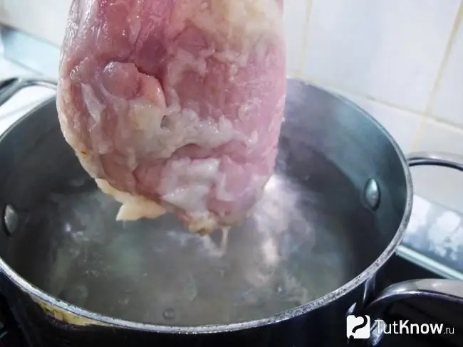 The meat is sent to boil in a pot of boiling water