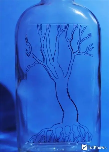 The contours of the tree on a glass bottle