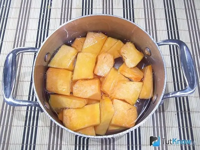 The pumpkin is peeled, sliced and dipped in a cooking pot