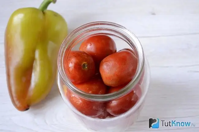 Tomatoes are stacked in a prepared jar