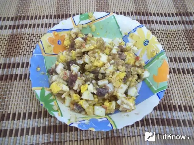 Ready-made Norwegian salad from herring caviar, eggs and apples