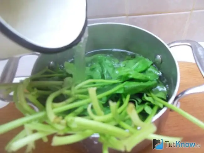 Spinach is covered with boiling water