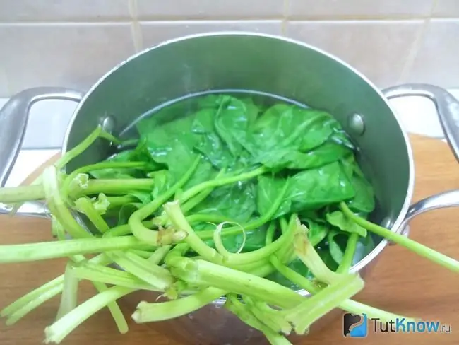 Spinach is covered with boiling water