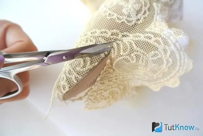 Cutting off excess parts of openwork fabric