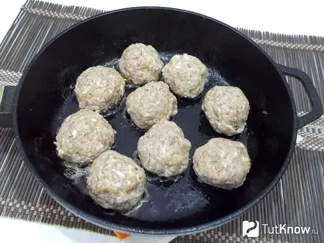 Meatballs are fried in a pan