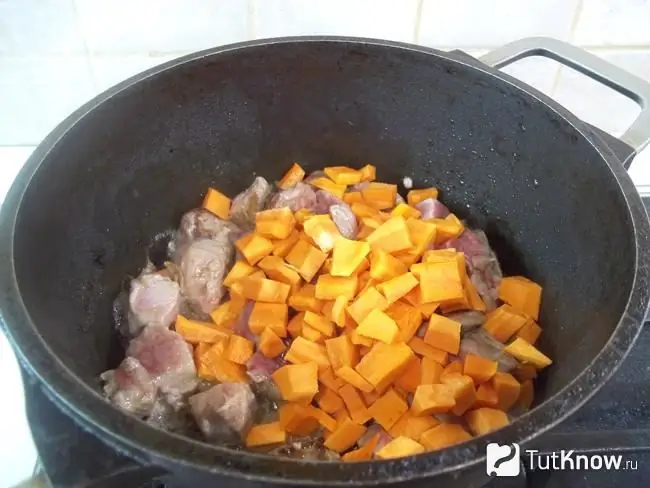 Sliced carrots added to the stewpan