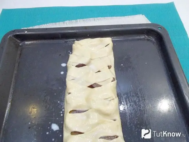 the roll is transferred to a baking sheet and sent to bake