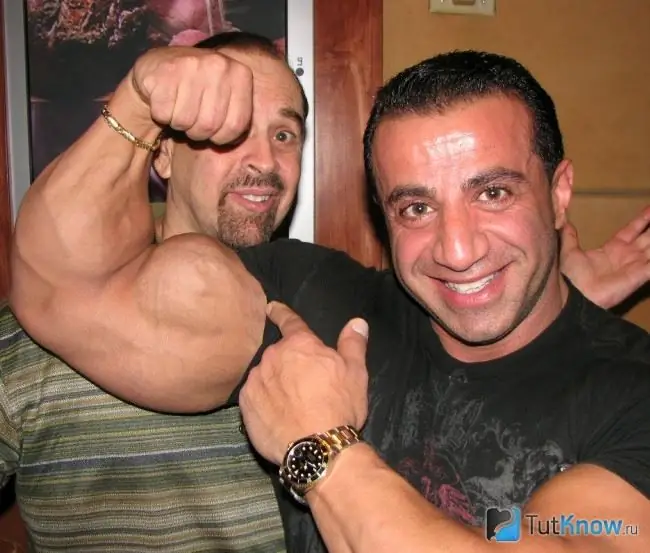 George Farah demonstrates arm muscles