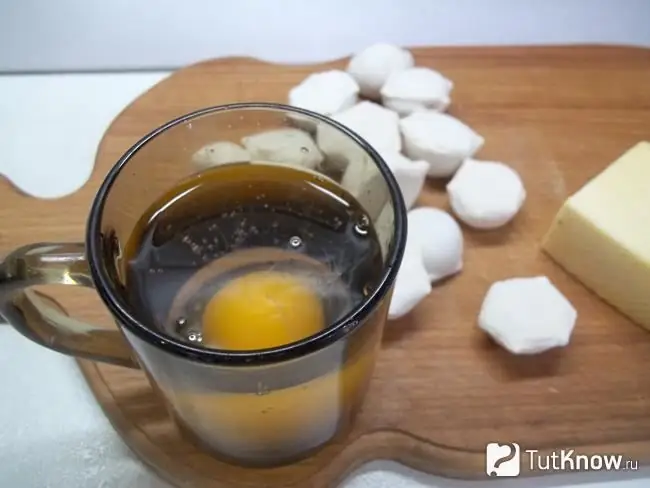 Un huevo sin cáscara se sumerge en un vaso de agua